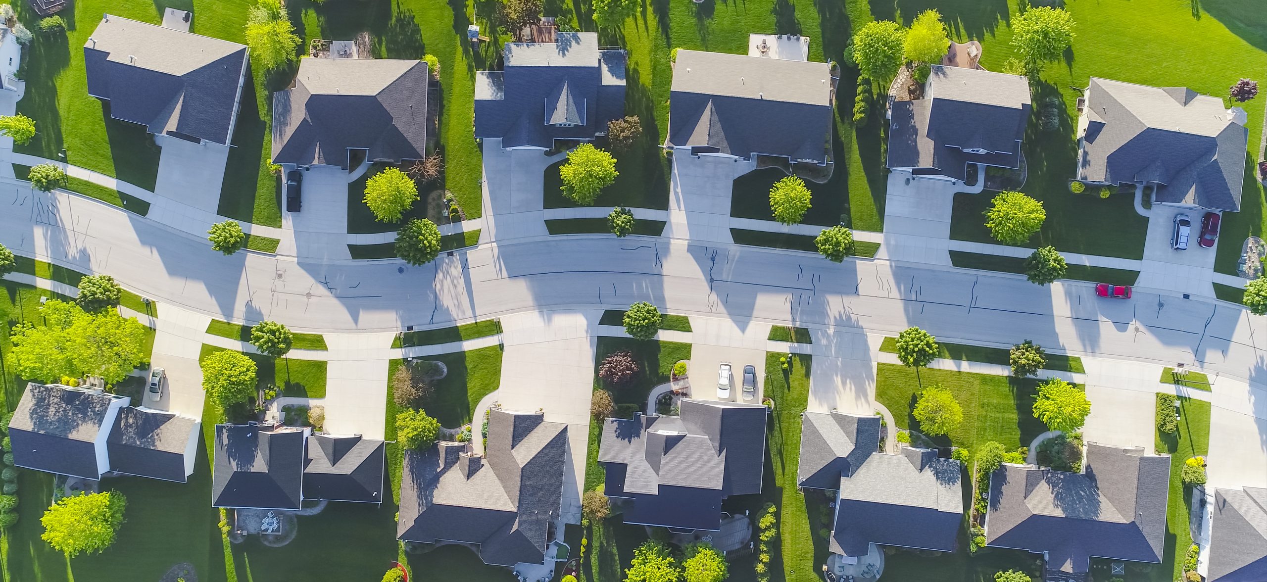 Aerial photo of a residential neighborhood street on a sunny day