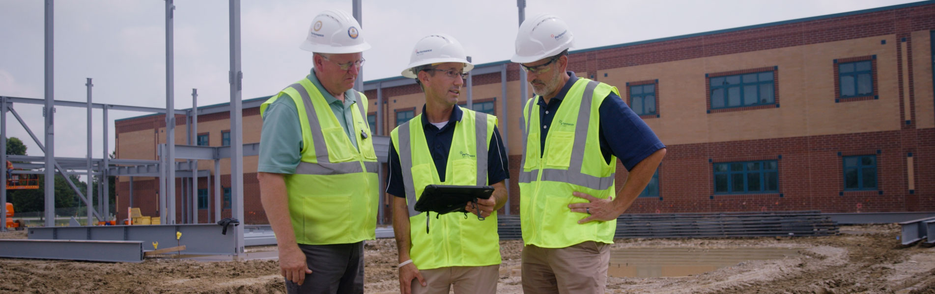 Performance Services design-build team collaborating on an active school project construction site