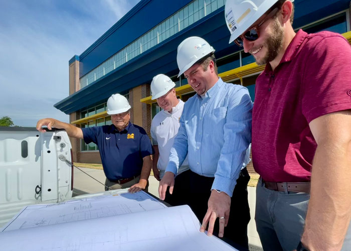 Performance Services design-build construction team reviewing project plans with a client