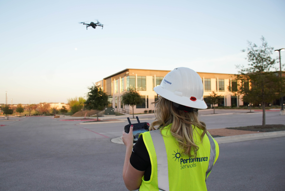 Performance Services' drone pilot using drone to assess facilities