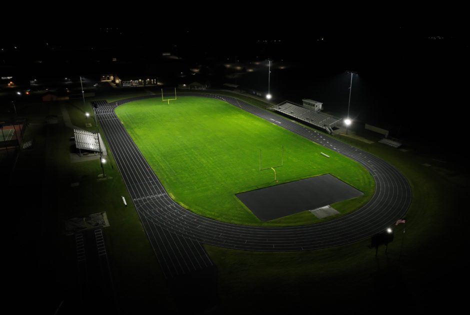 Aerial of East Troy High School's football stadium at night, showcasing new LED lighting