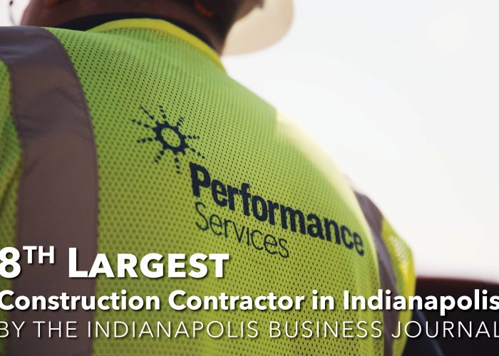 Close up of the back of a Performance Services safety vest with text overlaid that says "8th largest construction contractor in Indianapolis"