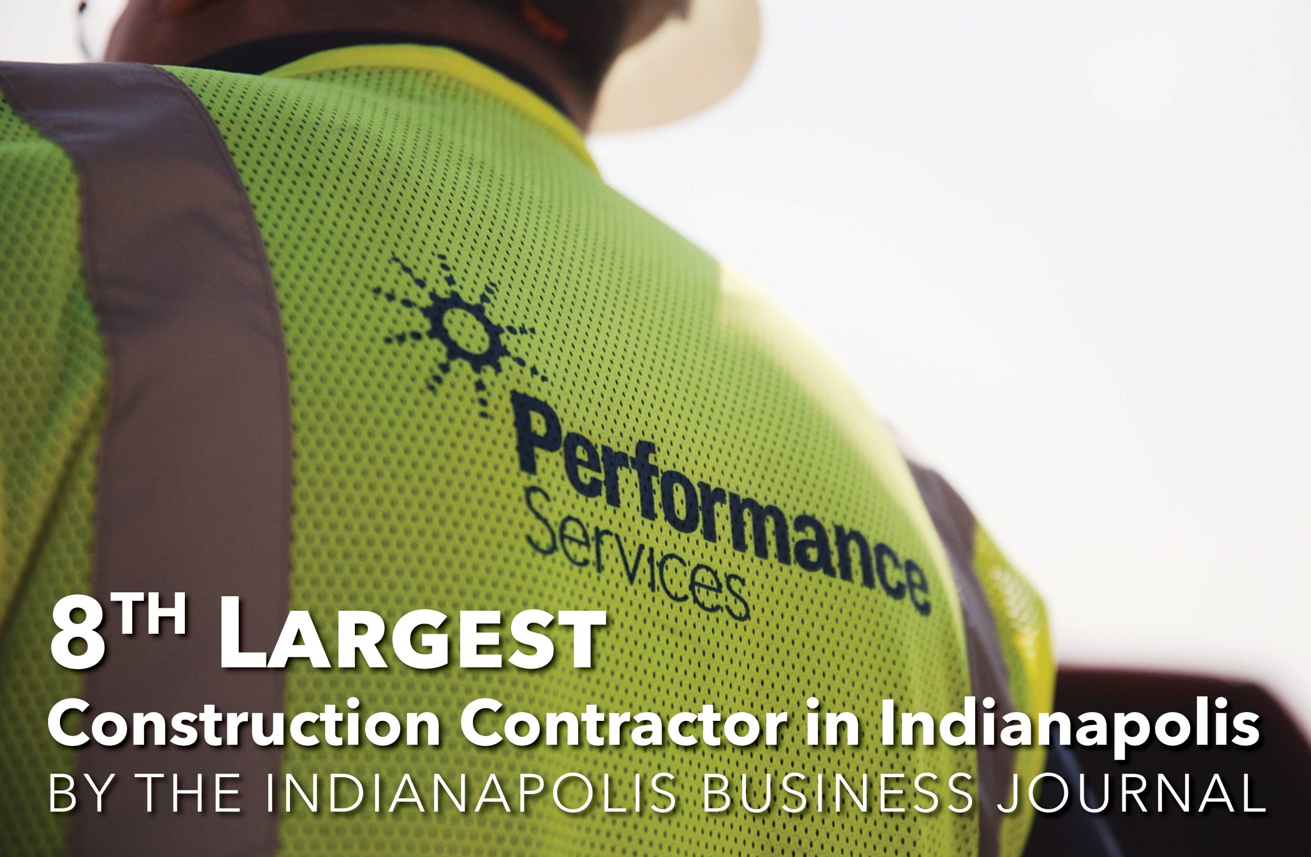 Close up of the back of a Performance Services safety vest with text overlaid that says "8th largest construction contractor in Indianapolis"